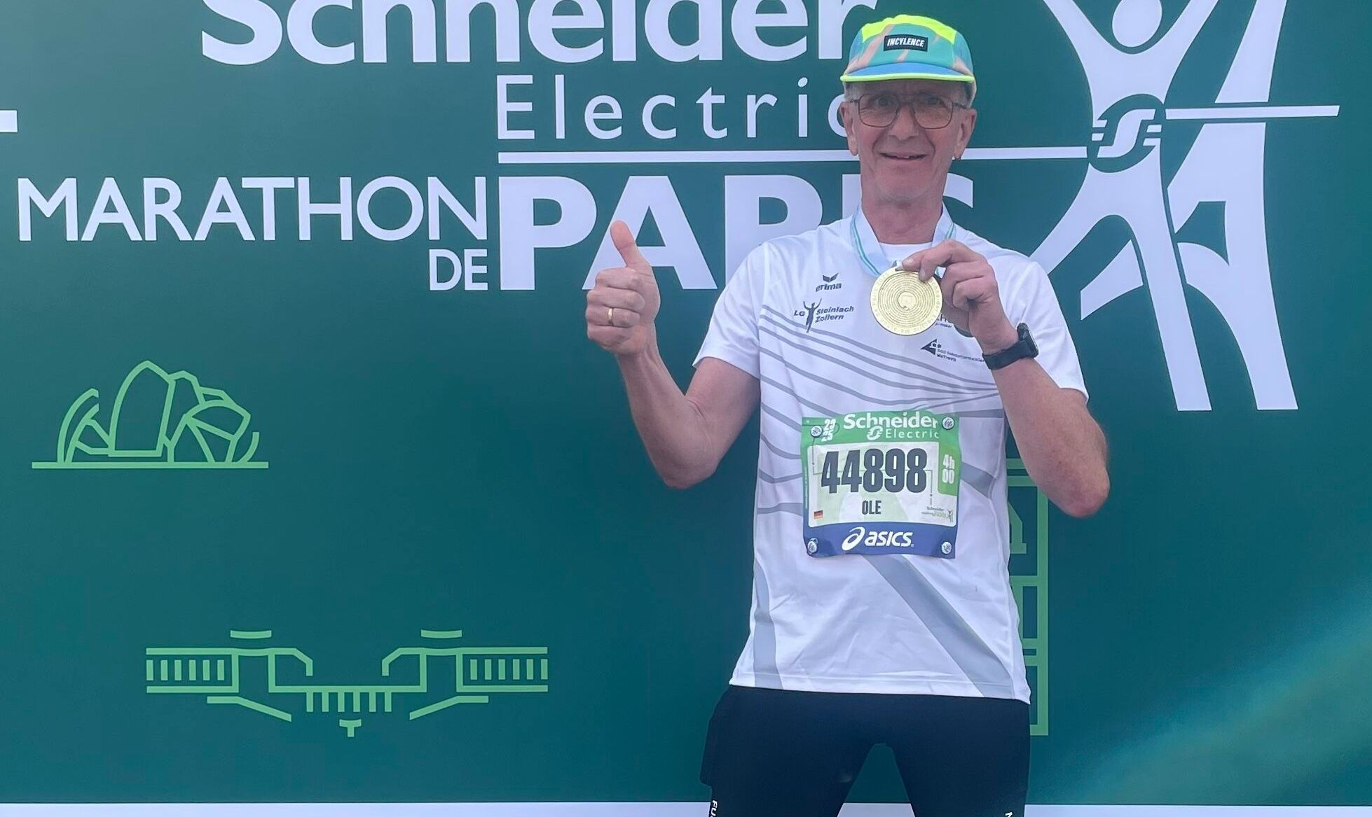 Ole Ahrens im Ziel präsentiert seine Medaille